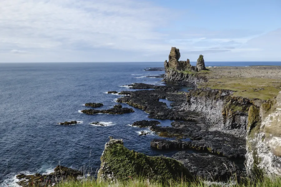 Basalt sea stacks rising from the Atlantic along Iceland's coast.